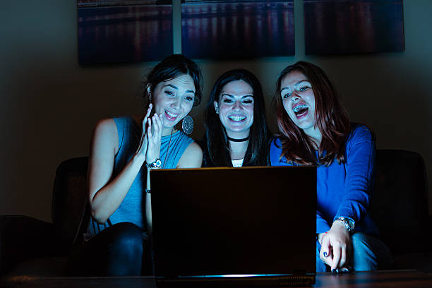 istock Three girlfriends, watchng something funny on laptop 639766410