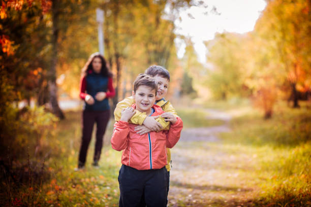 istock Mom with sons in the fall in forest Park 639767234