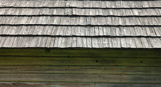 Old wooden house with shingle roof. Old traditional Ukrainian architecture.