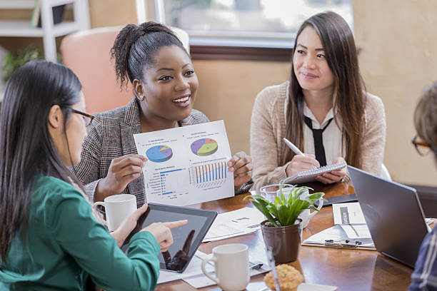 istock Diverse businesspeople discuss financials during meeting 639769906