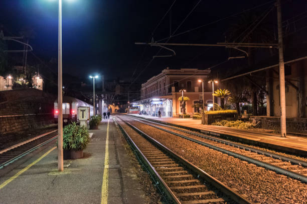 istock Night view on passenger platforms at train station in Italy 639770046