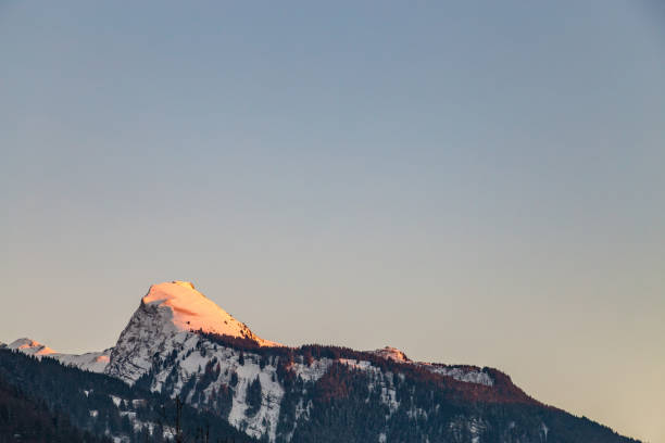 istock Snowy Mountain tops in the blue sky sun 639770086