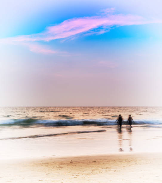 istock Vertical pale glow ocean landscape two man walking background ba 639771136