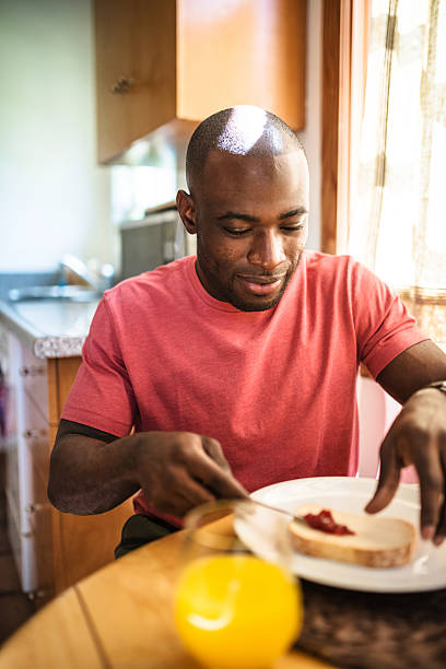 istock african guy doing breakfast at home 639771618