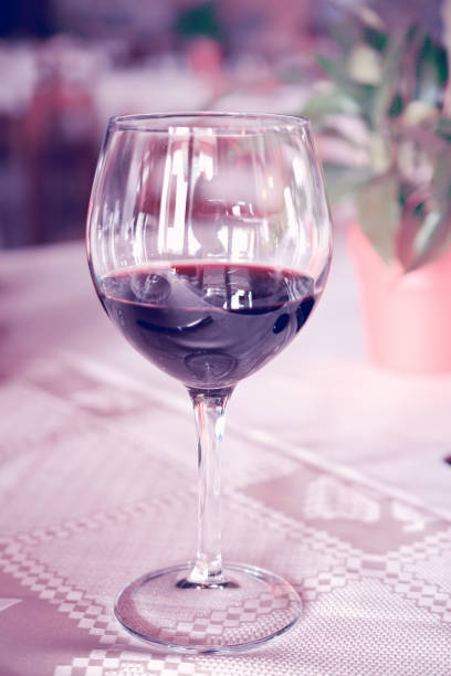 istock glass of wine on the table, light toning 639772868