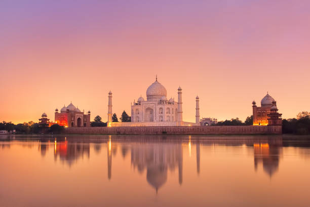 Taj Mahal in Agra, India on sunset Taj Mahal reflecting in a river on sunset, Agra, India indian dome stock pictures, royalty-free photos & images