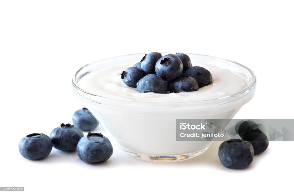 Clear bowl of yogurt with blueberries over white Clear bowl of yogurt with blueberries over a white background Yogurt Stock Photo
