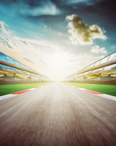 View of the infinity empty asphalt international race track, Motion blurred background . evening scene .