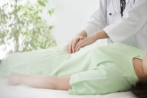 istock Doctor looking at symptoms while touching patient's gastrointestinal tract 639781150