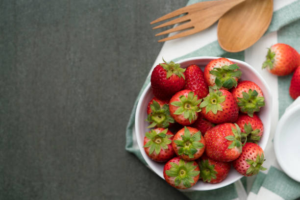 istock Fresh strawberries in a bowl on wooden table 639781486