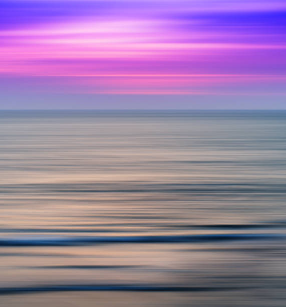 istock Vertical vivid vibrant pink ocean sunset landscape motion blur a 639782220