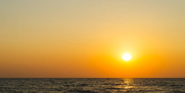 istock Horizontal vibrant orange ocean sunset background backdrop 639782534