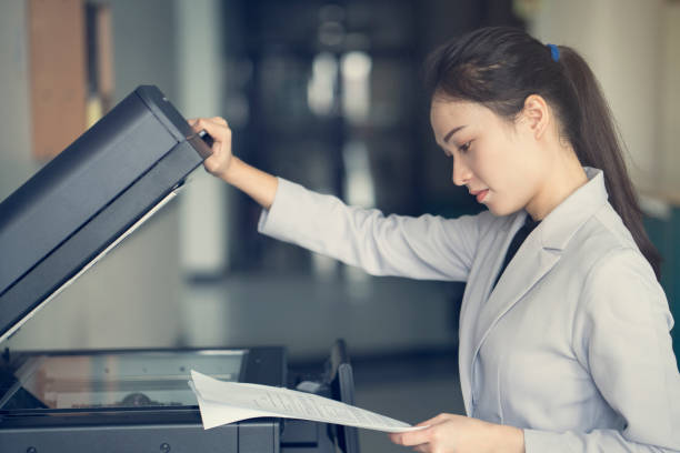 istock asian woman secretary using copy machine in the office 639782536