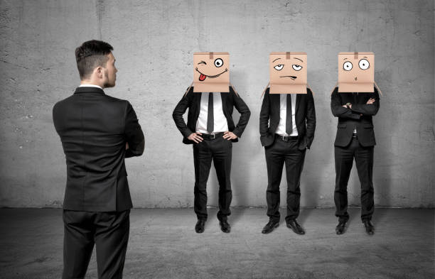 Businessman turned back and looking at three men wearing carton