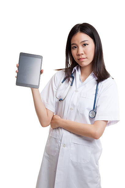 istock Asian young female doctor show tablet pc. 639783254