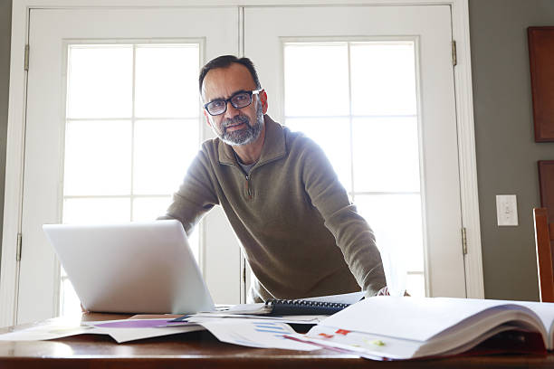 istock Hispanic Businessman Working From Home On Computer 639786268
