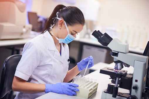 Shot of a young scientist transferring liquid from a pipette to a test tube in a laboratory