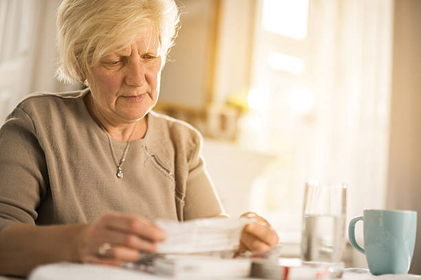 istock Old woman reading instructions for a medicine. 639794290