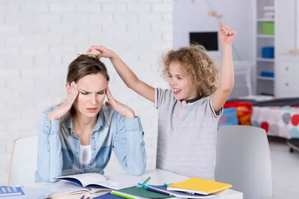 Photo of Child annoying his mother