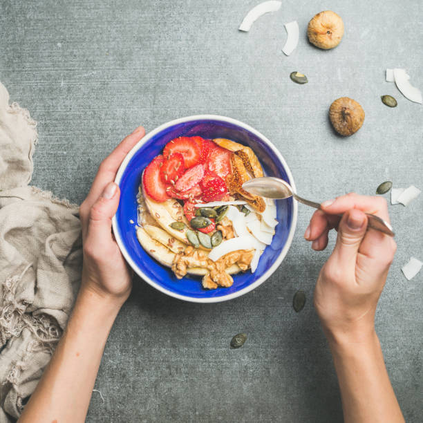 istock Woman's hands holding blue healthy breakfast bowl 639796324