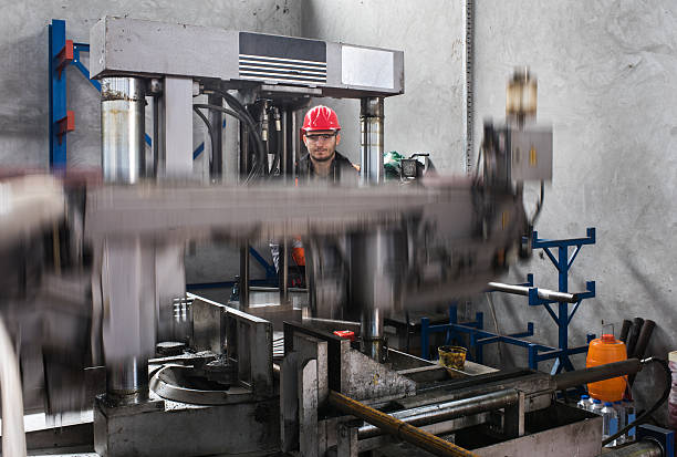 istock Metal worker working on a machine in a factory. 639796524