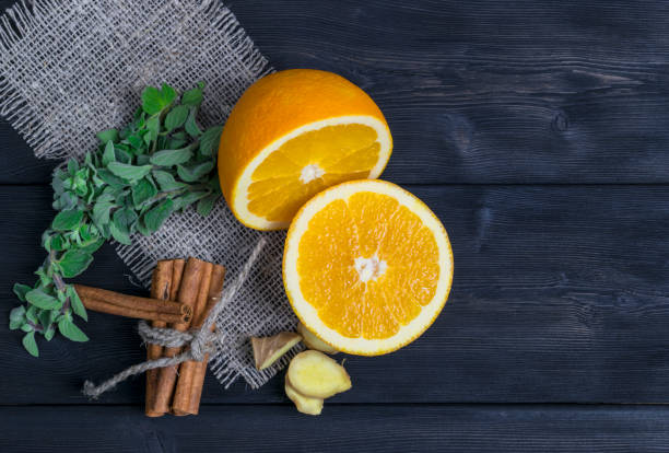 istock Orange fruit with cinnamon,ginger, mint on wooden texture background 639796920