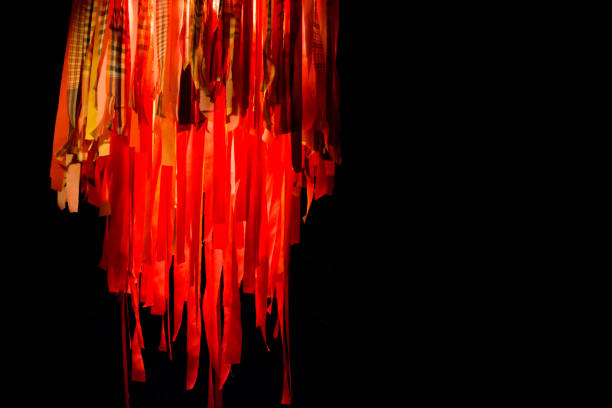 Hanging jellyfish lantern with long ribbons in red and orange is an eerie sight and illuminates the event.  Copyspace on right side.