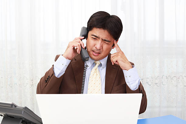 Tired and stressed Asian businessman