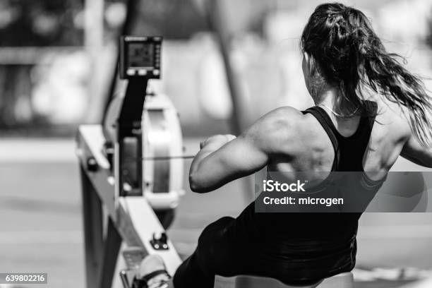 Woman Rowing Machine Cross Training Black And White Stock Photo - Download Image Now