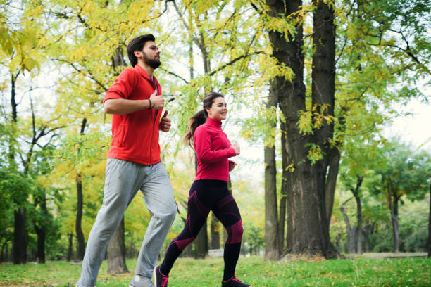 istock couple running in autumn park 639802762