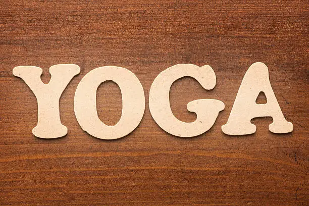 Photo of Yoga text on wooden desk