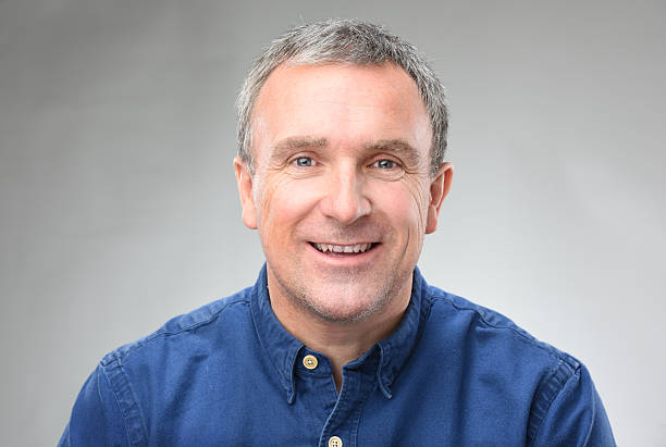 happy man a heads and shoulders shot of a smiling man in his late 40s . generic description stock pictures, royalty-free photos & images