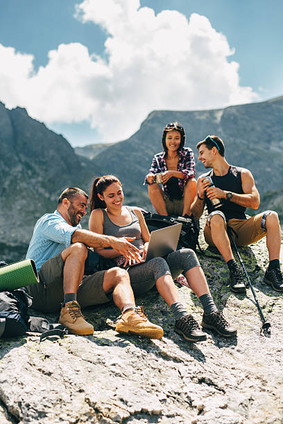 istock Friends browsing the net in the mountain 639808434