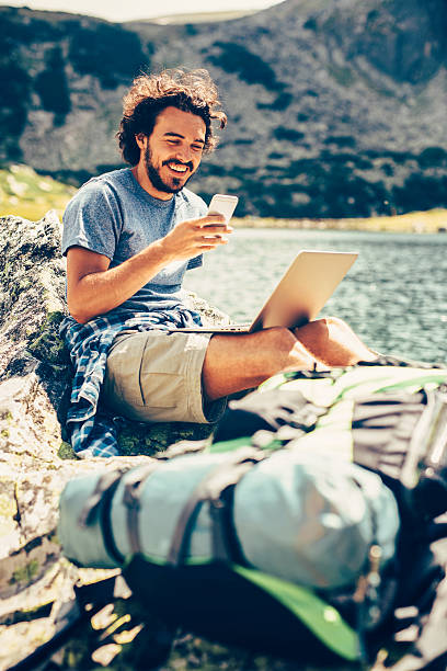 istock Man texting in the mountain 639808828