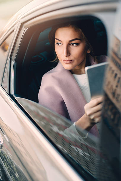 istock Woman using a tablet in a car 639809032
