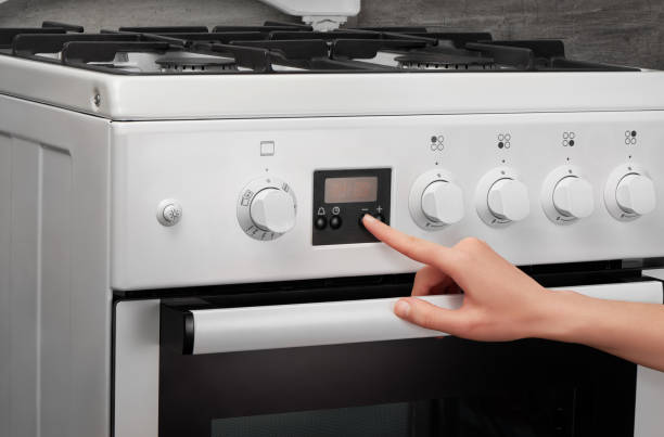 istock Female hand turning on white kitchen gas stove 639809498