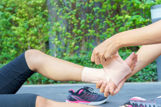 istock Young woman runner ankle being applied bandage by man 639809666