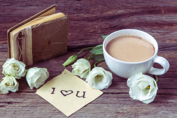 istock Coffee cup with spring flower lisianthus and notes 639811034