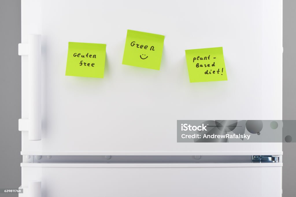 Gluten free, plant-based diet notes on refrigerator Gluten free, plant-based diet notes on green sticky paper on white refrigerator door Freedom Stock Photo