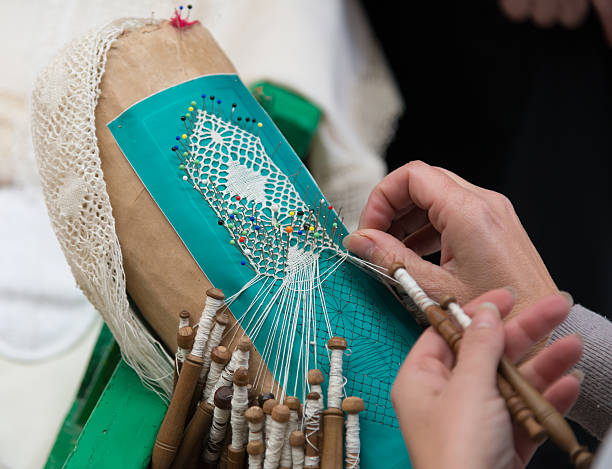 bobbin lacemaking - white lace with colorful needles