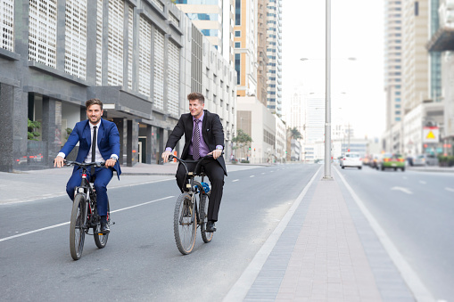 Business executives riding their bicycle to work