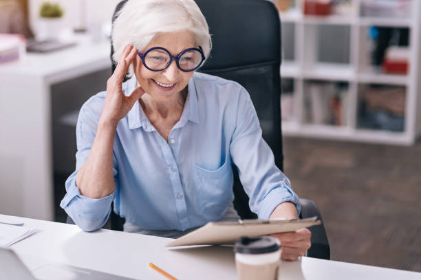 istock Involved charming aged woman working in the office 639817786