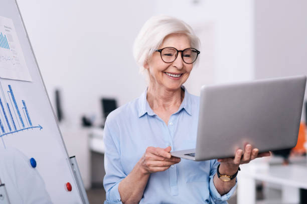 istock Creative aged businesswoman using laptop in the office 639819938
