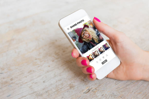 istock Woman using photo sharing app on phone 639822532