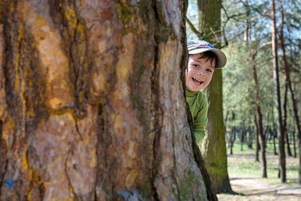 istock Adorable little boy playing hide and seek 639824062