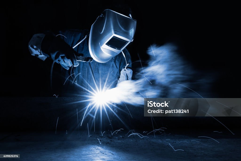 Welding Closeup industrial Worker at the factory welding Welder Stock Photo