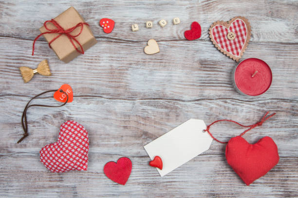 istock Valentine's Day background with red hearts on wooden table 639826208