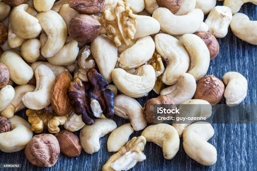 Mixture of dried fruits on a dark background Photo taken of a toy, indoors at 200 iso, at f 20, 2.5 seconds with the help of a flash and ambient light with macro lens Amuse Bouche Stock Photo