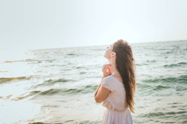 istock female enjoying the sun on beach 639829008