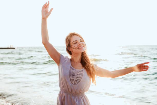 istock female enjoying the sun on beach 639829122
